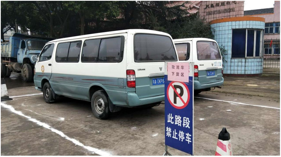 Foreign vehicles load and unload cargo in designated areas outside the factory